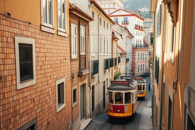 Yellow tram on a steep tiled street in Lisbon, Portugal